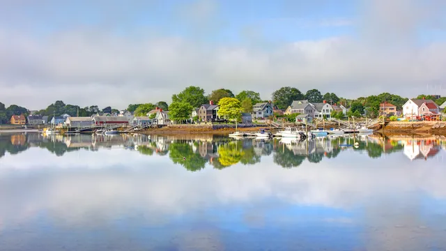 Waterfront homes and moored boats along a calm New Hampshire Seacoast harbor